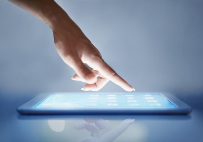 Closeup of a young woman holding a touch sensitive digital tablet