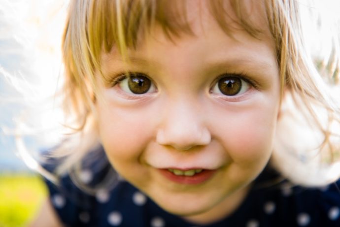Detail of cute little girl looking to you