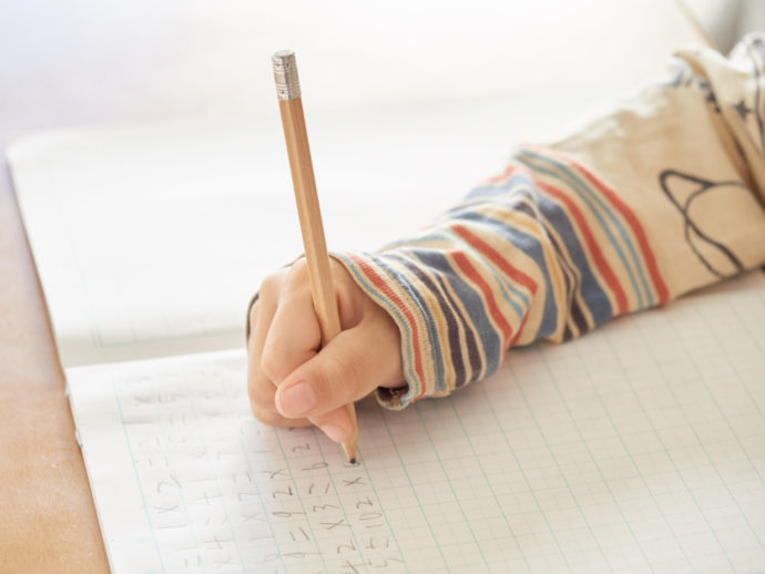 自宅で算数の宿題をする小学生の男の子